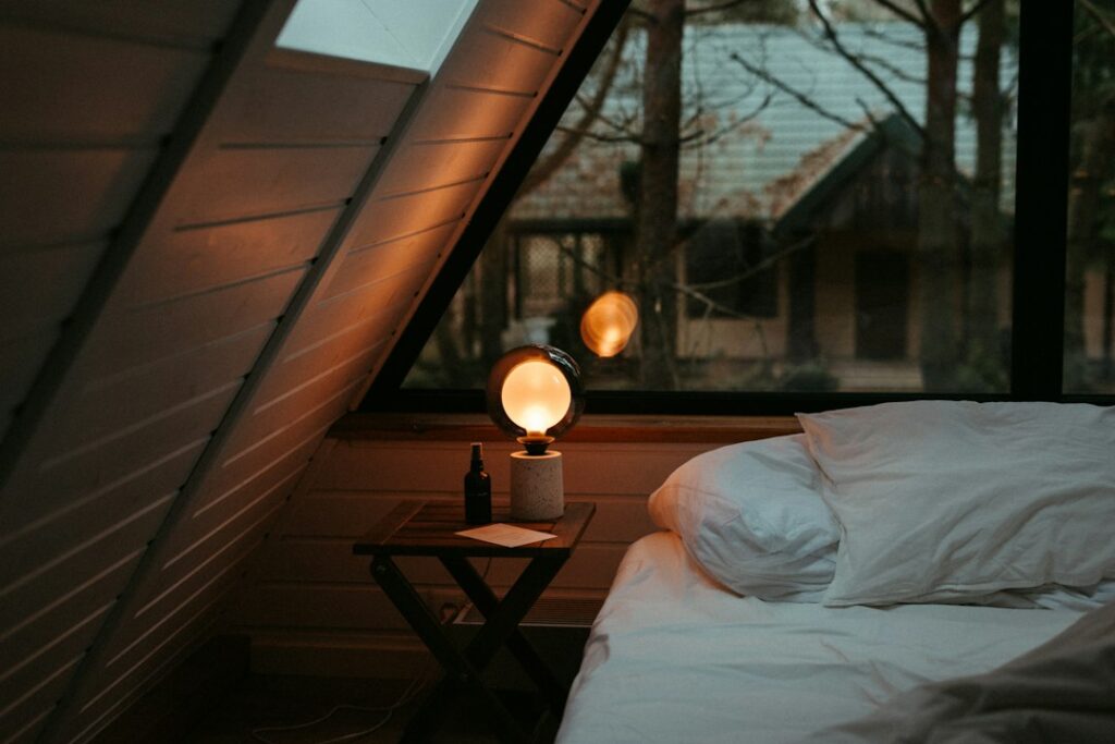 A bed beside a window and nightstand