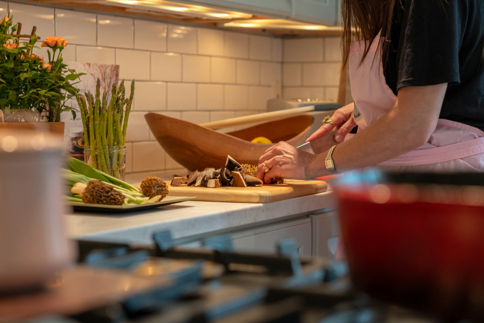 A person chopping vegetables in a kitchen.