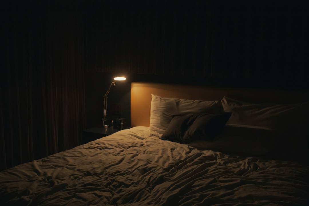 A bedside lamp illuminating a bedroom